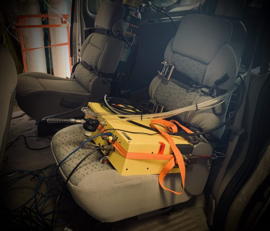 A Firefly PEMS unit in a van strapped to a seat