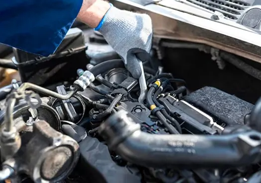 A person with their hand in an engine