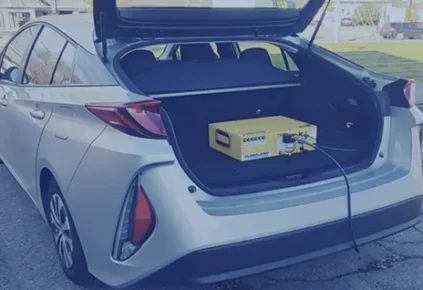 A picture of an EV vehicle with a PEMS device in the trunk