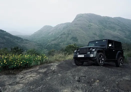 An ICE vehicle going off roading on a mountain