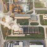 An aerial view of a smoke stack at an industrial facility