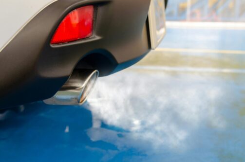 A picture of tailpipe exhaust coming out of a sedan vehicle