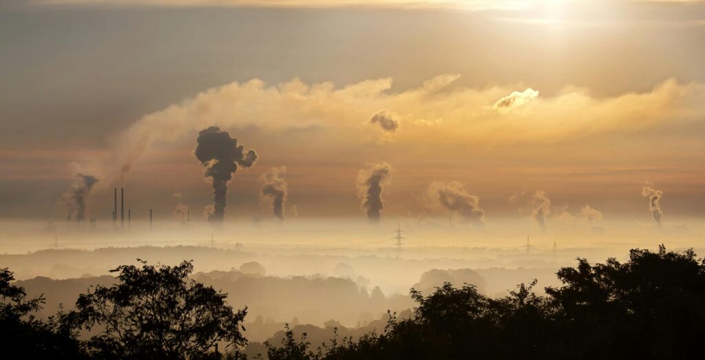 A picture of smog on the horizon with industrial smoke going into the air